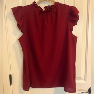 Solid print cap sleeve ruffle neck blouse.